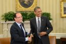 Barack Obama (R) shakes hands with Francois Hollande in the Oval Office at the White House on May 18, 2012