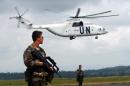 A UN French special forces soldier watches over the situation while a UN helicopter lands on June 10, 2003, on Bunia airport in the Democratic Republic of Congo