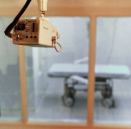 FILE - In this July 30, 1997, file photo a television camera mounted on the ceiling of a witness room is pointed toward the death chamber at Cummins Prison in Varner, Ark. The Arkansas Supreme Court struck down the state's execution law Friday, June 22, 2012, calling it unconstitutional. (AP Photo/Danny Johnston, File)