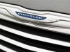 A Chrysler badge is pictured on a new car at a dealership in Vienna, Virginia