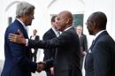 Haitian President Michel Martelly (C) welcomes US Secretary of State John Kerry upon his arrival at the National Palace in Port-au-Prince, on October 6, 2015