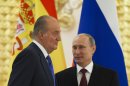 Russian President Vladimir Putin, right, speaks to Spain's King Juan Carlos as he awards him with Russian State Award for humanitarian activism in 2010 in the Kremlin in Moscow, Russia, Thursday, July 19, 2012. (AP Photo/Alexander Zemlianichenko)