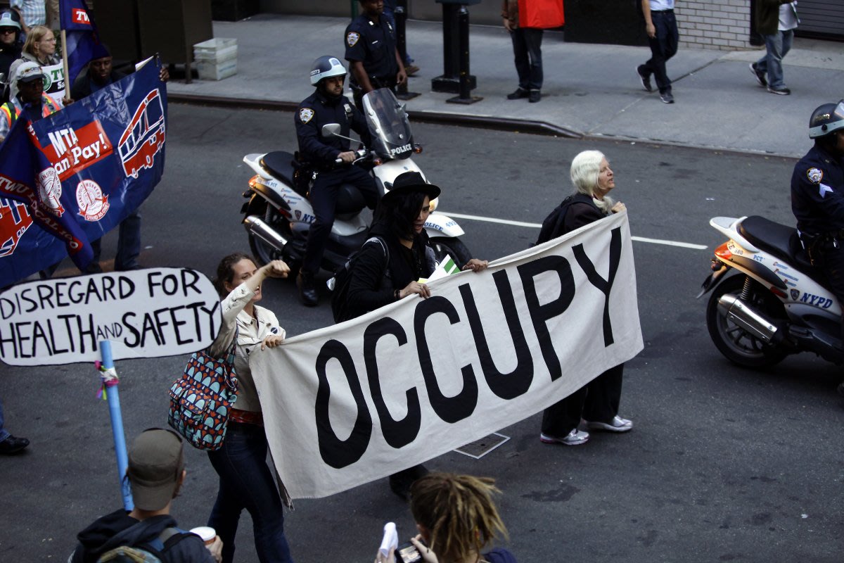 Occupy Wall Street protesters march along 47th Street in New York ...