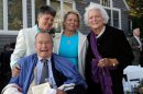 In this Sept. 21, 2013 photo, former President George H.W. Bush, front left, former first lady Barbara Bush, right, pose for photos after wedding of longtime friends Helen Thorgalsen, center, and Bonnie Clement, in Kennebunkport, Maine. Bush was an official witness at the same-sex wedding, his spokesman said Wednesday, Sept. 25, 2013. (AP Photo/Susan Biddle)
