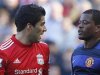 Liverpool's Suarez and Manchester United's Evra look look at each other during their English Premier League soccer match at Anfield in Liverpool