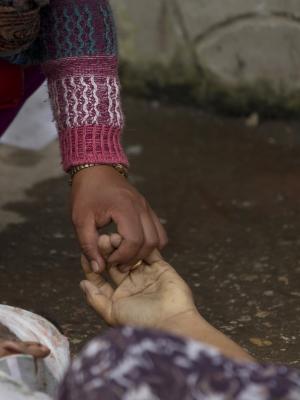 A Nepalese woman holds the hand of her relative killed &hellip;