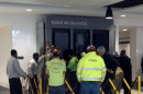 People hold up a message board sign that fell on a family killing a child and injuring the mother and two other children in the terminal at the Birmingham-Shuttlesworth International Airport in Birmingham, Ala., Friday, March 22, 2013. (AP Photo/ AL.com, Carol Robinson) MAGS OUT