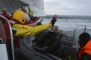 According to Greenpeace, a man identified as a Russian coast guard officer points a knife at a Greenpeace International activist, during a protest near a Gazprom oil platform in the Pechora Sea