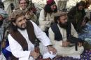 FILE - In this file photo taken Sunday, Oct. 4, 2009, new Pakistani Taliban chief Hakimullah Mehsud, left, is seen with his comrade Waliur Rehman, front center, during his meeting with media in Sararogha of Pakistani tribal area of South Waziristan along the Afghanistan border. Intelligence officials said Friday, Nov. 1, 2013 that the leader of the Pakistani Taliban Hakimullah Mehsud was one of three people killed in a U.S. drone strike. (AP Photo/Ishtiaq Mehsud, File)