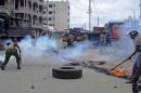 Kenyan police fire tear gas during riots sparked by the killing of a Muslim cleric in the port city of Mombasa, on October 4, 2013