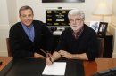 This image released by ABC shows Disney President and CEO Robert Iger, left, and filmmaker George Lucas of LucasFilm Ltd. at a contract signing in Burbank, Calif., Tuesday, Oct. 30, 2012. The Walt Disney Co. announced Tuesday that it was buying Lucasfilm Ltd. for $4.05 billion. (AP Photo/Disney, Rick Rowell)