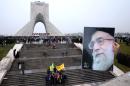 An Iranian man holds a portrait of Supreme Leader Ayatollah Ali Khamenei during a rally commemorating the 36th anniversary of Islamic Revolution under Azadi Tower, Tehran, Iran, Wednesday, Feb. 11, 2015. Iran marked the anniversary of its 1979 Islamic Revolution on Wednesday with massive rallies, with many chanting against the U.S. and Israel as the country tries to reach a permanent deal with world powers over its contested nuclear program. (AP Photo/Ebrahim Noroozi)