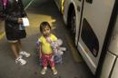 In this photo taken July 1, 2014, two-year-old Adriana Ortez holds her stuffed animal, as she and her mother, Dayana Ortez, of El Salvador, wait to board a bus leaving the city bus station in McAllen, Texas. Ortez and her daughter, were released on their own recognizance by U.S. Customs and Border Protection Services after entering the illegally into the U.S. from Mexico. The mother and daughter were heading to Los Angles to reunite with family. (AP Photo/Austin American-Statesman, Rodolfo Gonzalez)