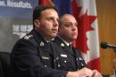 Royal Canadian Mounted Police assistant commissioner James Malizia, left, and Inspector Paul Mellon speak at a press conference at RCMP headquarters in Ottawa, Ontario, about the arrest of a Somali man Ali Omar Ader, for his involvement in the kidnapping of Canadian journalist Amanda Lindhout and Australian photojournalist Nigel Brennan, Friday, June 12, 2015. (Patrick Doyle/The Canadian Press via AP) MANDATORY CREDIT