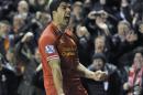 Liverpool's Luis Suarez celebrates after he scores the fourth goal of the game for his side during their English Premier League soccer match against Everton at Anfield in Liverpool, England, Tuesday Jan. 28, 2014. (AP Photo/Clint Hughes)