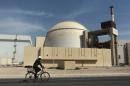 FILE - In this Oct. 26, 2010 file photo, a worker rides a bicycle in front of the reactor building of the Bushehr nuclear power plant, just outside the southern city of Bushehr, Iran. The chances for progress between Iran, the U.S. and its partners have seldom been better. This is the message coming from Iran and six world powers ahead of renewed talks this week meant to end a decade of deadlock on Tehran's nuclear program. (AP Photo/Mehr News Agency, Majid Asgaripour, File)