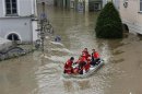 A rescue team on a dinghy evacuates a man from the flooded district of the Bavarian town of Passau