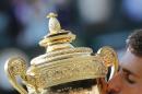Novak Djokovic of Serbia kisses the trophy after defeating Roger Federer of Switzerland in the men's singles final match at the All England Lawn Tennis Championships in Wimbledon, London, Sunday July 6, 2014.(AP Photo/Ben Curtis)