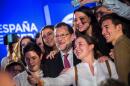 Spanish Prime Minister and candidate for the upcoming general election, Mariano Rajoy, poses with supporters for a selfie after a meeting in Valencia on December 18, 2015