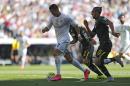 Real Madrid's Cristiano Ronaldo, left, tussles for the ball with Granada's Miguel Lopes during a Spanish La Liga soccer match between Real Madrid and Granada at the Santiago Bernabeu stadium in Madrid, Saturday, Sept. 19, 2015. (AP Photo/Francisco Seco)