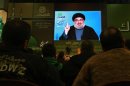 Hezbollah leader Sheik Hassan Nasrallah speaks via a video link, during a ceremony to mark Islam's Prophet Muhammad's birth in the southern suburbs of Beirut, Lebanon, Friday, Jan. 25, 2013. Nasrallah, a staunch ally of the Syrian regime, said those who had dreamed about "dramatic changes" taking place in Syria should let go of their dreams. He said all military, political and international indications showed that President Bashar Assad's regime cannot be defeated. (AP Photo/Bilal Hussein)