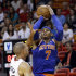 New York Knicks forward Carmelo Anthony (7) takes a shot against Miami Heat forward Shane Battier during the second half of an NBA basketball game, Tuesday, April 2, 2013 in Miami. Anthony tied his career high with 50 points in the Knicks' 102-90 win. (AP Photo/Wilfredo Lee)