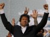 Pakistani cricketer turned politician and head of Pakistan Tahreek-e-Insaf or Movement for Justice Party Imran Khan waves to his supporters during a rally in Lahore, Pakistan on Sunday, Oct. 30, 2011. Khan railed against the government and its alliance with the U.S. before an energized crowd of over 100,000 flag-waving supporters Sunday, establishing himself as a force to be reckoned with in Pakistani politics. (AP Photo/K.M. Chaudary)