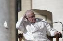 A gust of wind blows away Pope Francis' skullcap during his weekly general audience in Saint Peter's Square at the Vatican