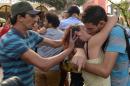 A man tries to stop a couple from taking part in a "kiss-in" outside the parliament in the Moroccan capital Rabat on October 12, 2013
