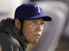 Texas Rangers Uehara sits in the dugout against the Los Angeles Angels during their MLB game in Anaheim