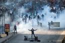 Muslim Brotherhood and Morsi supporters clash with Egyptian riot police during a demonstration on December 6, 2013 in Cairo