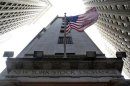 The U.S. flag waves in the breeze above one of the entrances to the New York Stock Exchange, November 19, 2012. REUTERS/Chip East