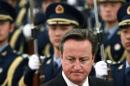 British PM Cameron inspects the guard of honour during an official welcoming ceremony in Beijing