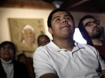 Lopez watches along with others as President Obama speaks about immigration reform on a television monitor at a restaurant in Phoenix