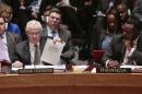 U.N. Russian Ambassador Vitaly Churkin shows a document as he speaks during a meeting of the U.N. Security Council, Monday, March 3, 2014 at U.N. headquarters. (AP Photo/Bebeto Matthews)