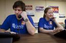 Bryan Munks, 19, of Arlington, Va., left, and Priscilla Houk, 17, of Fairfax, Va., make calls for the Romney campaign while wearing quick response code stickers, known as QR codes, in Fairfax, Va., on Tuesday, June 19, 2012. The presidential ground game has gone high tech, marrying old-school organizing work with innovative digital tools. The T-shirts that Romney campaign volunteers wear in Virginia feature a digital code that voters can zap with their smart phones to learn more about the Republican presidential hopeful, which gives Romney field organizers valuable information on how to reach them in the future. (AP Photo/Jacquelyn Martin)