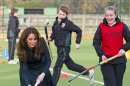 Kate, the Duchess of Cambridge, left, plays hockey during her visit to St. Andrew's School, where she attended school from 1986 till 1995, in Pangbourne, England, Friday, Nov. 30, 2012. The Duchess of Cambridge has gone back to school. The royal, formerly known as Kate Middleton, played hockey and revealed her childhood nickname — Squeak — when she returned to her elementary school for a visit Friday. Kate told teachers and students at the private St. Andrew's School in southern England that her 10 years there were "some of my happiest years." She said that she enjoyed it so much that she had told her mother she wanted to return as a teacher. (AP Photo/Arthur Edwards, Pool)