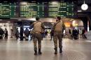 Belgian soldiers patrol in the arrival hall at Midi railway station in Brussels