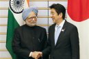 India's PM Singh shakes hands with his Japanese counterpart Abe at the start of talks at Abe's official residence in Tokyo