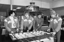 FILE - In this Feb. 10, 1980, file photo, U.S. Olympic ice hockey players, from left, Michael Eruzione, Phil Verchota, John Harrington and Bob Suter play foosball in the game room of the Olympic village in Lake Placid, N.Y. Suter, a member of the 