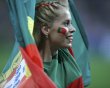 Portugal team supporter with the painted face and national flag cheers before the start of their Group B Euro 2012 soccer match against Germany in Lviv