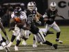 Denver Broncos running back Moreno is tackled by Oakland Raiders cornerback Bartell during their NFL football game in Oakland