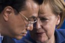 German Chancellor Angela Merkel, right, and the Chinese Premier Li Keqiang attend a news conference after a meeting at the chancellery in Berlin, Sunday, May 26, 2013. (AP Photo/Markus Schreiber)