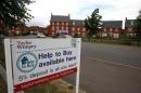 A sign is seen outside newly built houses in Aylesbury, southern England
