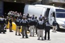 Drug Enforcement Administration agents waits outside the Roberto Clemente Coliseum to transport the arrests of two organizations with large -scale narcotics trafficking at Puerto Rico's Luis Munoz Marin International Airport