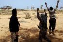 Libya Dawn fighters celebrate as a Libya Dawn aircraft bombed Islamic State militant positions near Sirte