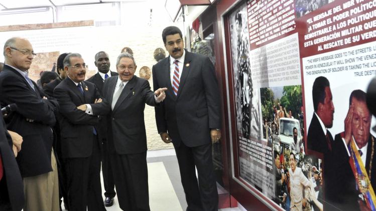 Cuba's President Castro gestures next to his Venezuelan counterpart Maduro during the inauguration at a museum dedicated to late Venezuelan President Hugo Chavez in Havana