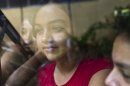 Mayerling Rivera, a Nicaraguan girl suffering from leukemia, looks through a window during preparations of a "quinceanera" party in Managua, Nicaragua, Saturday Sept. 21, 2013. For each of the past five years, Nicaragua's Association of Mothers and Fathers of Children with Cancer and Leukemia has put on a "quinceanera" party for girls from poor, rural families, teens who have the added burden of dealing with cancer. This year's party feted 37 girls between ages 14 and 16 on Saturday night at a hotel in Nicaragua's capital.(AP Photo/Esteban Felix)