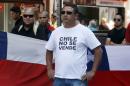A Chilean nationalists with a t-shirt that reads in Spanish, "Chile is not for Sale", shows his displeasure at the recent world court ruling in Santiago, Chile, Jan. 27, 2014. The United Nations' highest court set a maritime boundary between Chile and Peru, granting the latter a bigger piece of the Pacific Ocean but keeping rich coastal fishing grounds in Chilean hands. (AP Photo/ Luis Hidalgo).