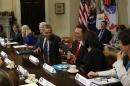 U.S. President Obama reaches clasps hands with Facebook COO Sandberg during a meeting in Washington